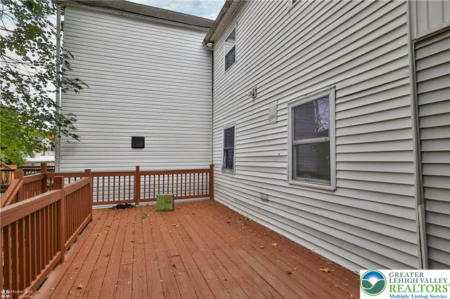 a view of a yard with plants and trees
