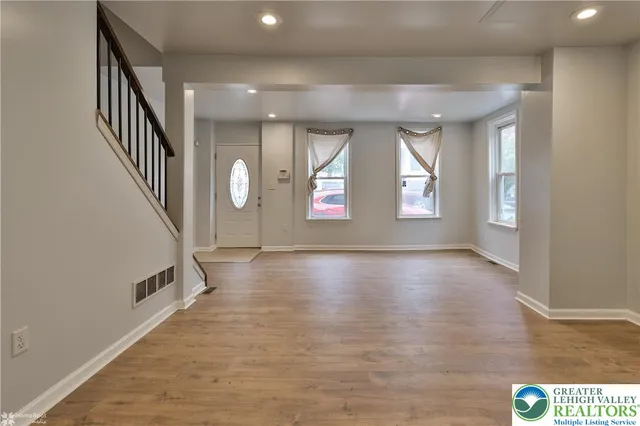 a kitchen with granite countertop a stove a sink and a refrigerator