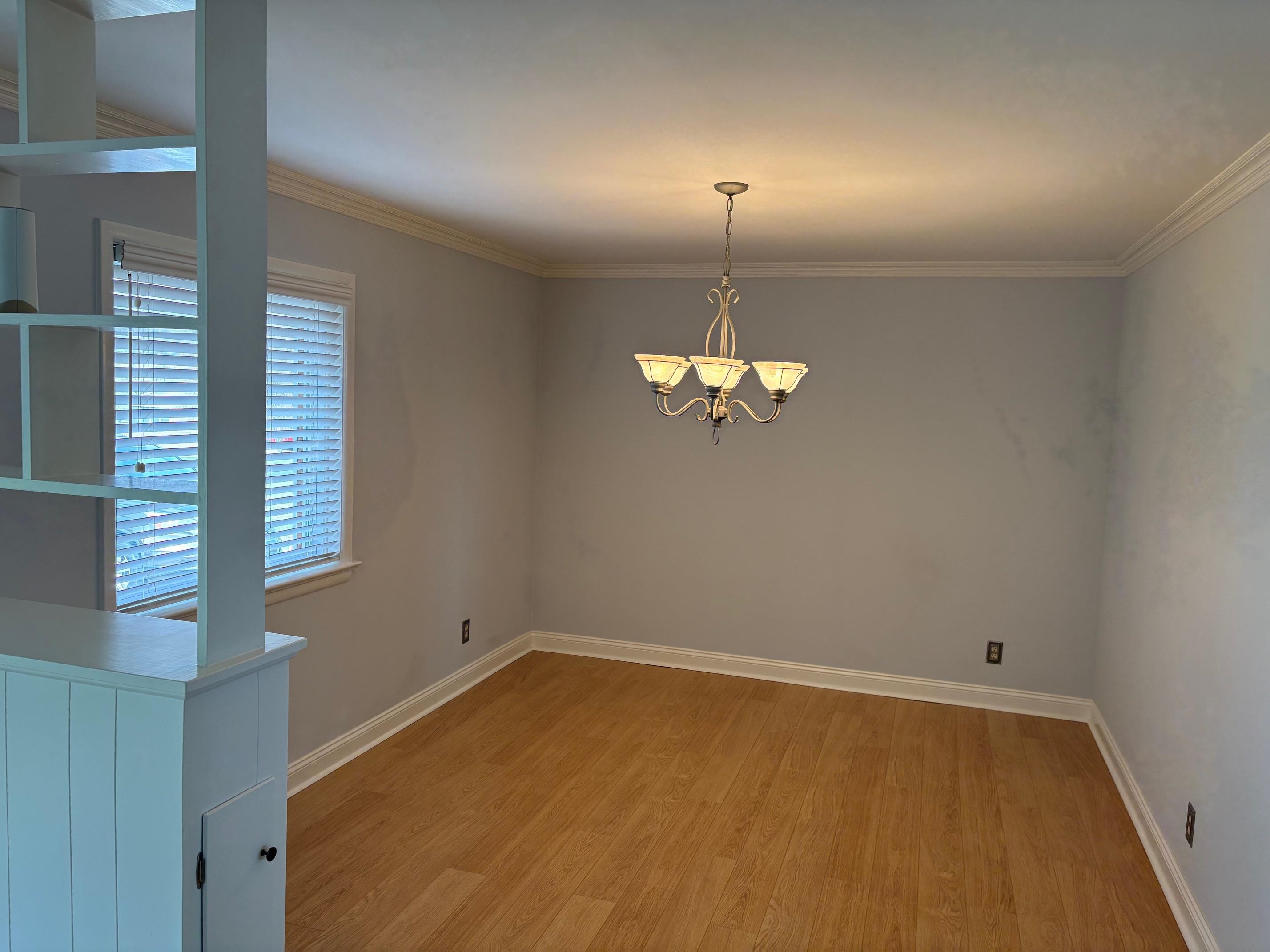 48 Confederate Street Verona, VA 24482 - Photo 11 of 47 an empty room with a chandelier fan and wooden floor