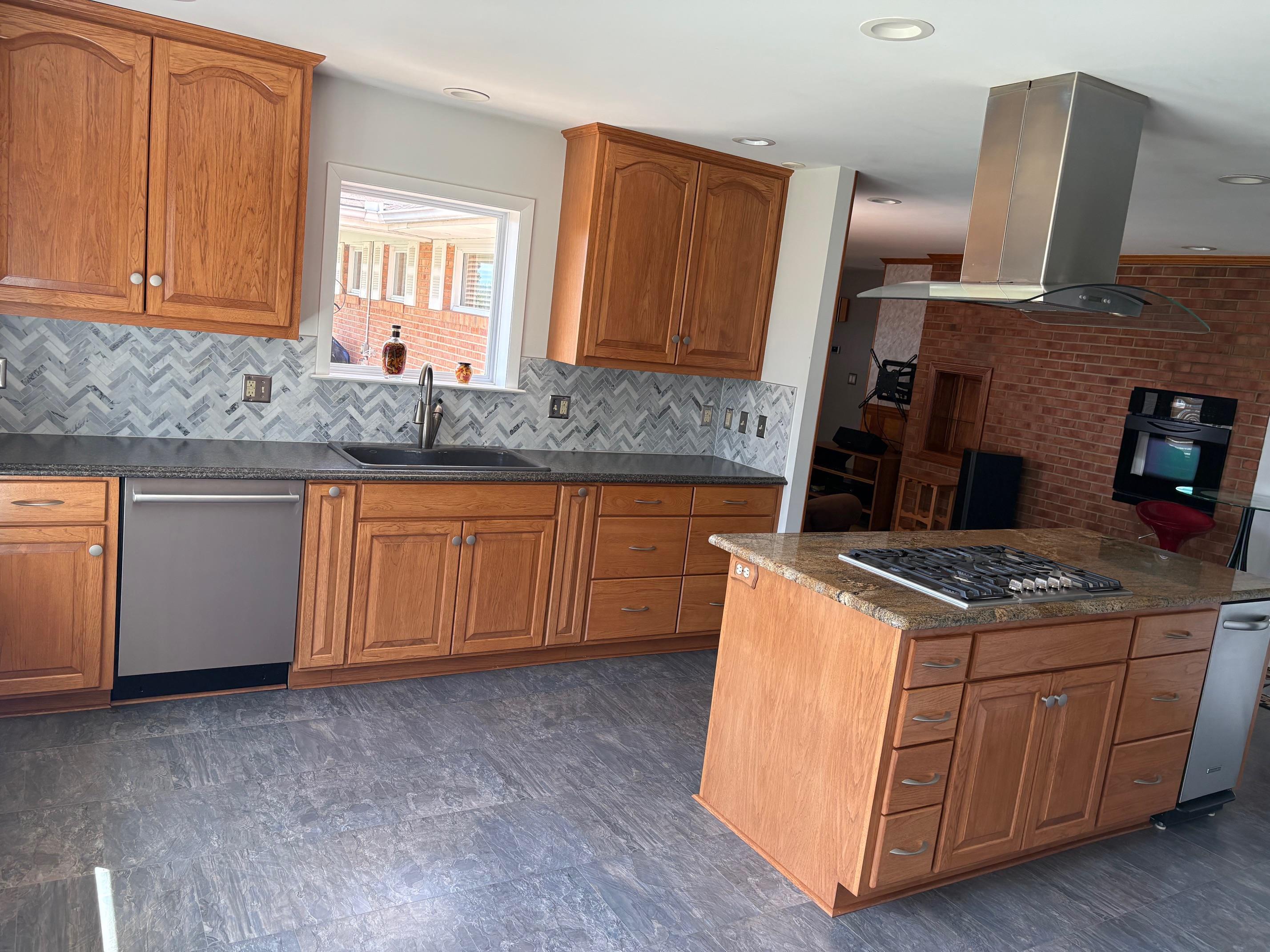 48 Confederate Street Verona, VA 24482 - Photo 4 of 47 a kitchen with granite countertop a stove top oven sink and cabinets