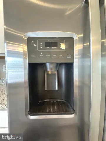 a view of kitchen with kitchen island sink and refrigerator