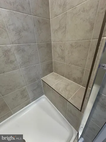 a bathroom with a shower and a toilet