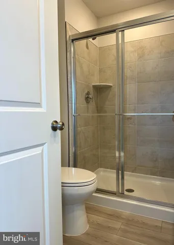 a bathroom with a sink a toilet and a large mirror