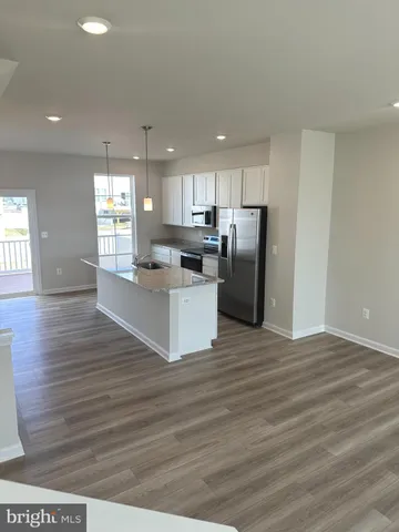 a kitchen with stainless steel appliances granite countertop a refrigerator sink and cabinets