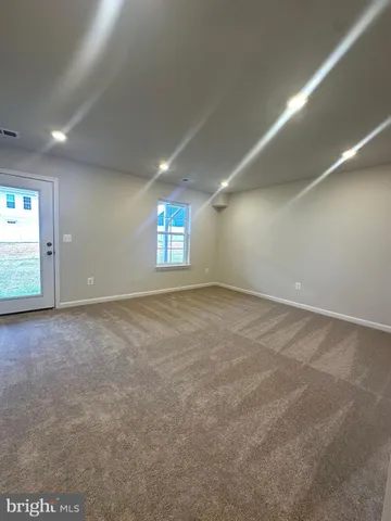 an empty room with a empty space and windows