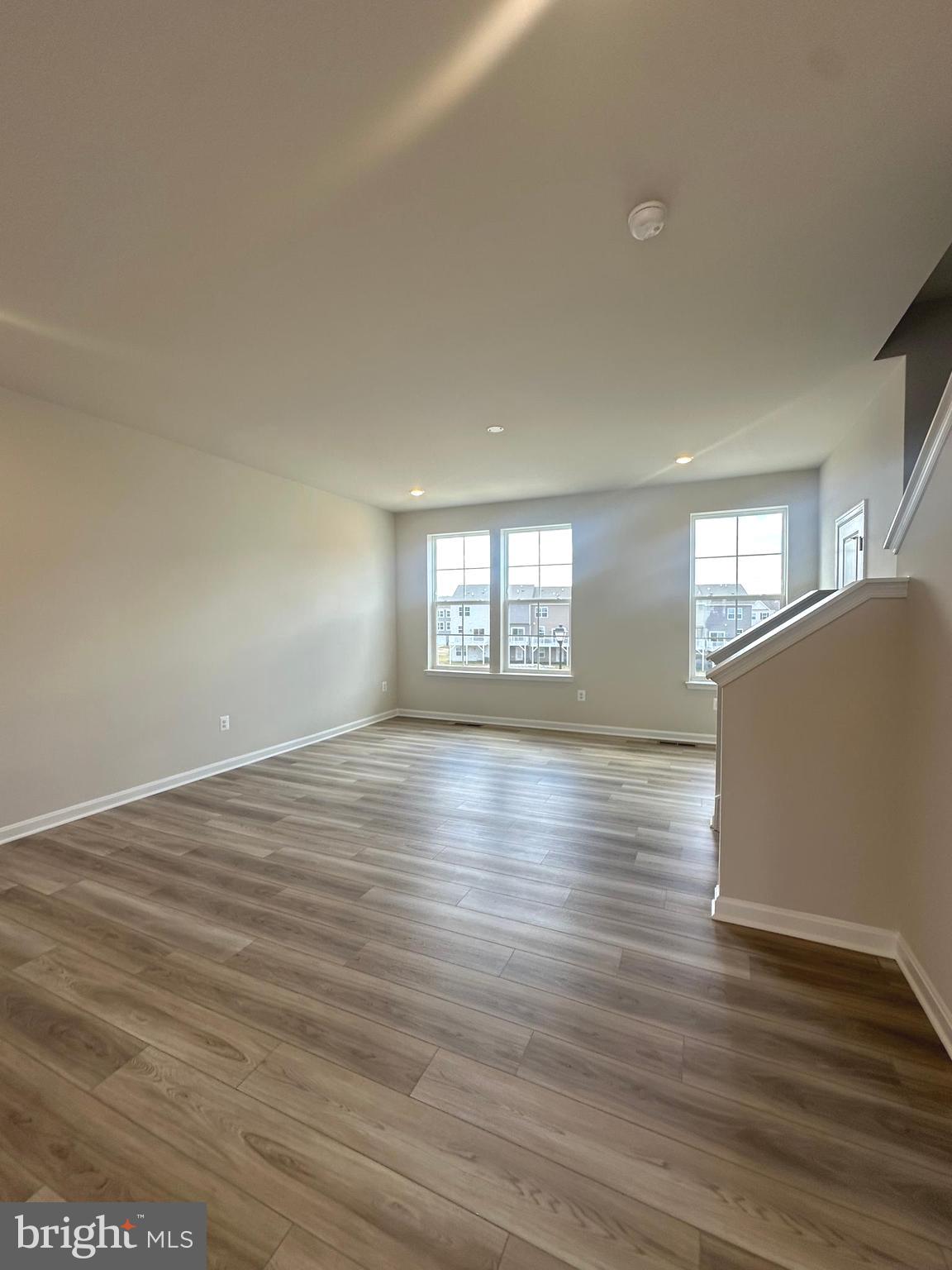106 Telluride Way Charles Town, WV 25414 - Photo 41 of 55 an empty room with wooden floor and windows