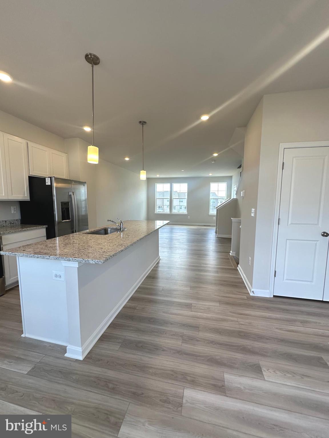 106 Telluride Way Charles Town, WV 25414 - Photo 5 of 55 a large kitchen with kitchen island a island wooden floor and a ceiling fan