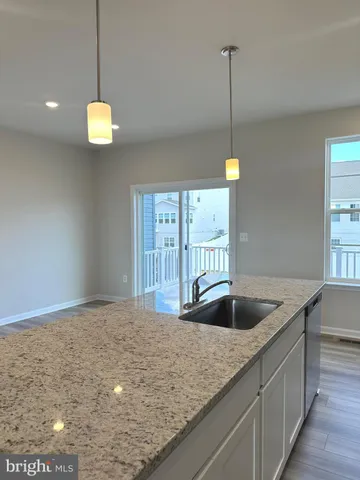 a kitchen with kitchen island a counter top a sink and appliances