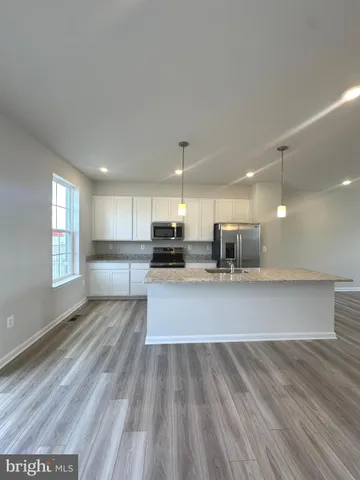 a view of kitchen with sink microwave and outdoor view