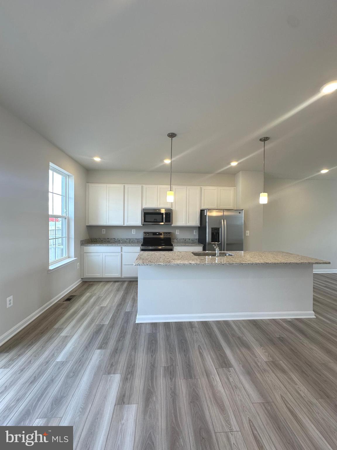 106 Telluride Way Charles Town, WV 25414 - Photo 7 of 55 a view of kitchen with sink microwave and outdoor view