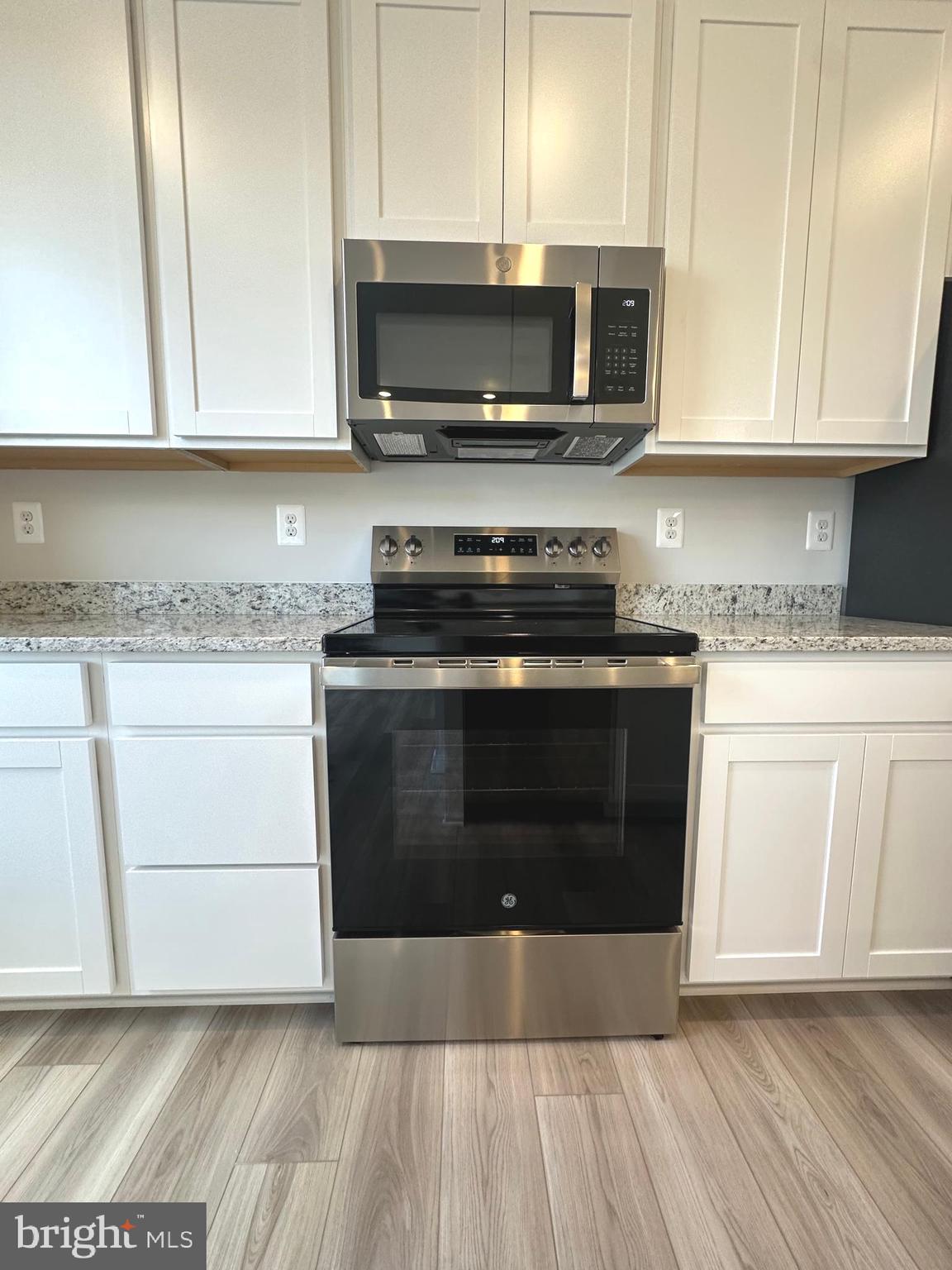 106 Telluride Way Charles Town, WV 25414 - Photo 8 of 55 a kitchen with stainless steel appliances granite countertop a stove a microwave a sink and cabinets