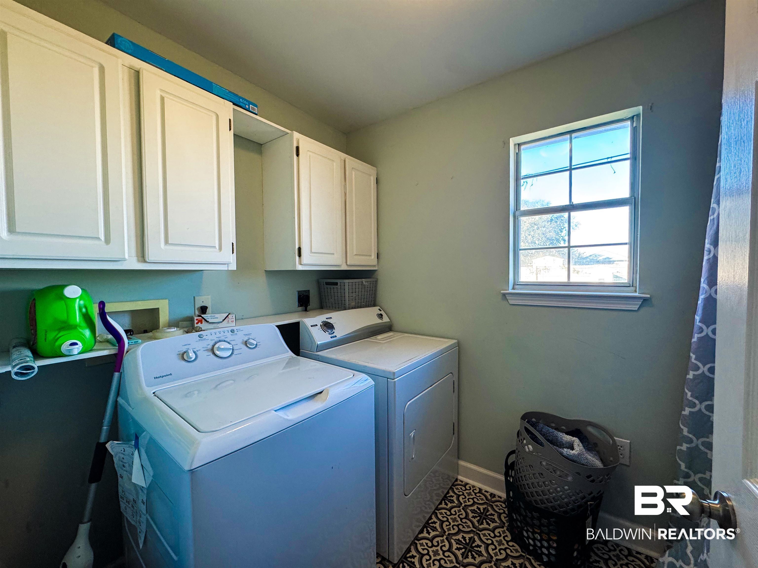 8927 Gryder Street Foley, AL 36535 - Photo 16 of 18 Clothes washing area featuring cabinet space, baseboards, and independent washer and dryer