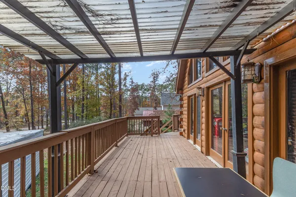 a view of balcony with wooden floor and fence