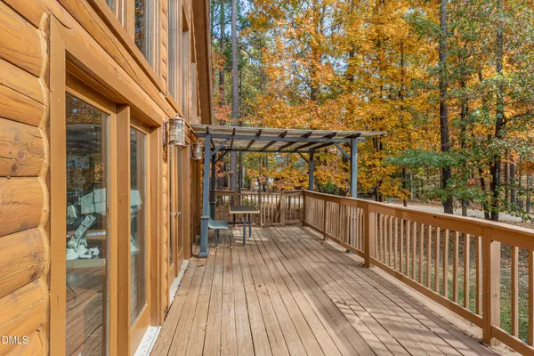 a front view of a house with wooden deck