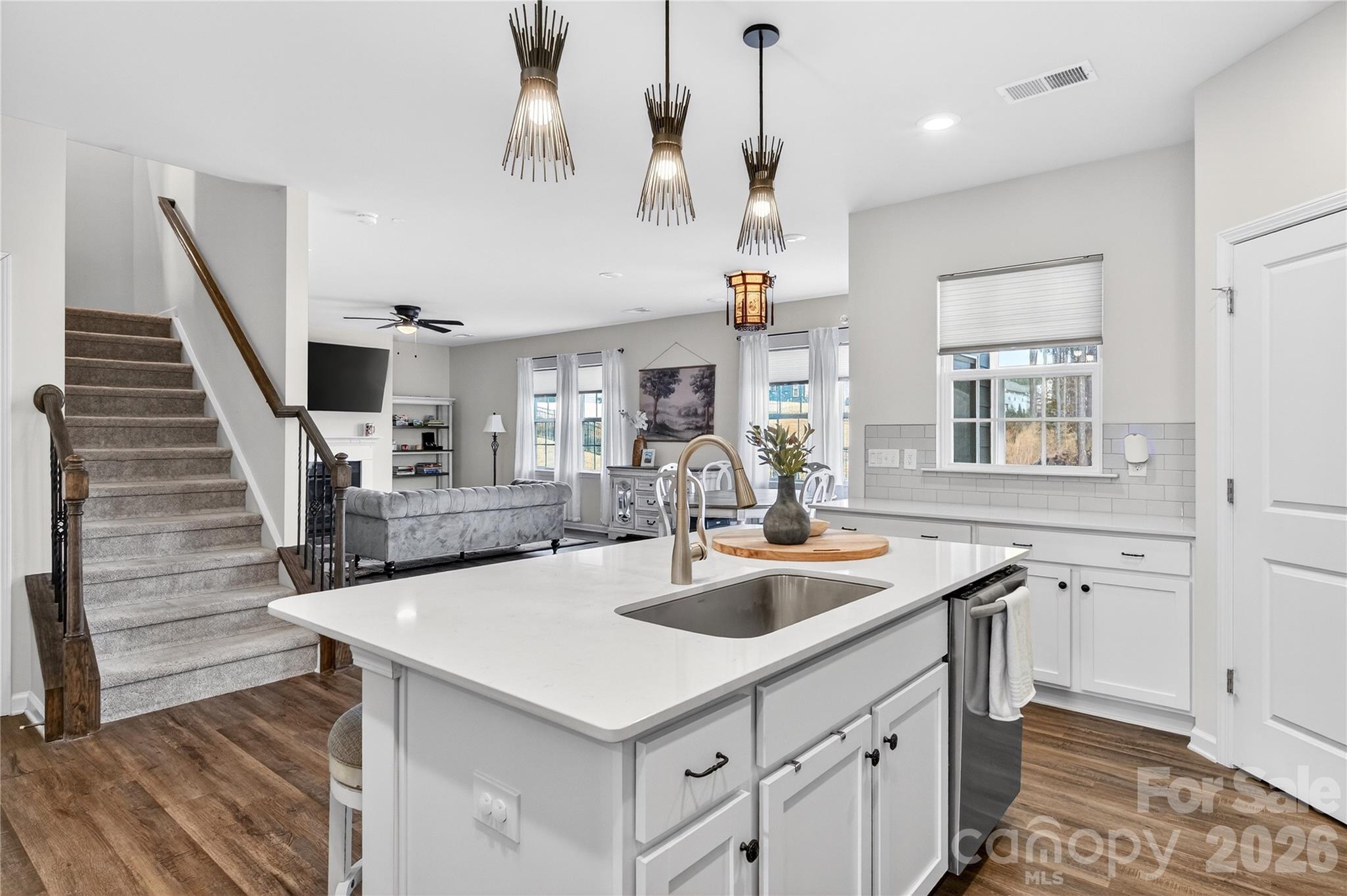 151 Outrigger Lane Troutman, NC 28166 - Photo 17 of 39 a kitchen with stainless steel appliances granite countertop a sink and a refrigerator