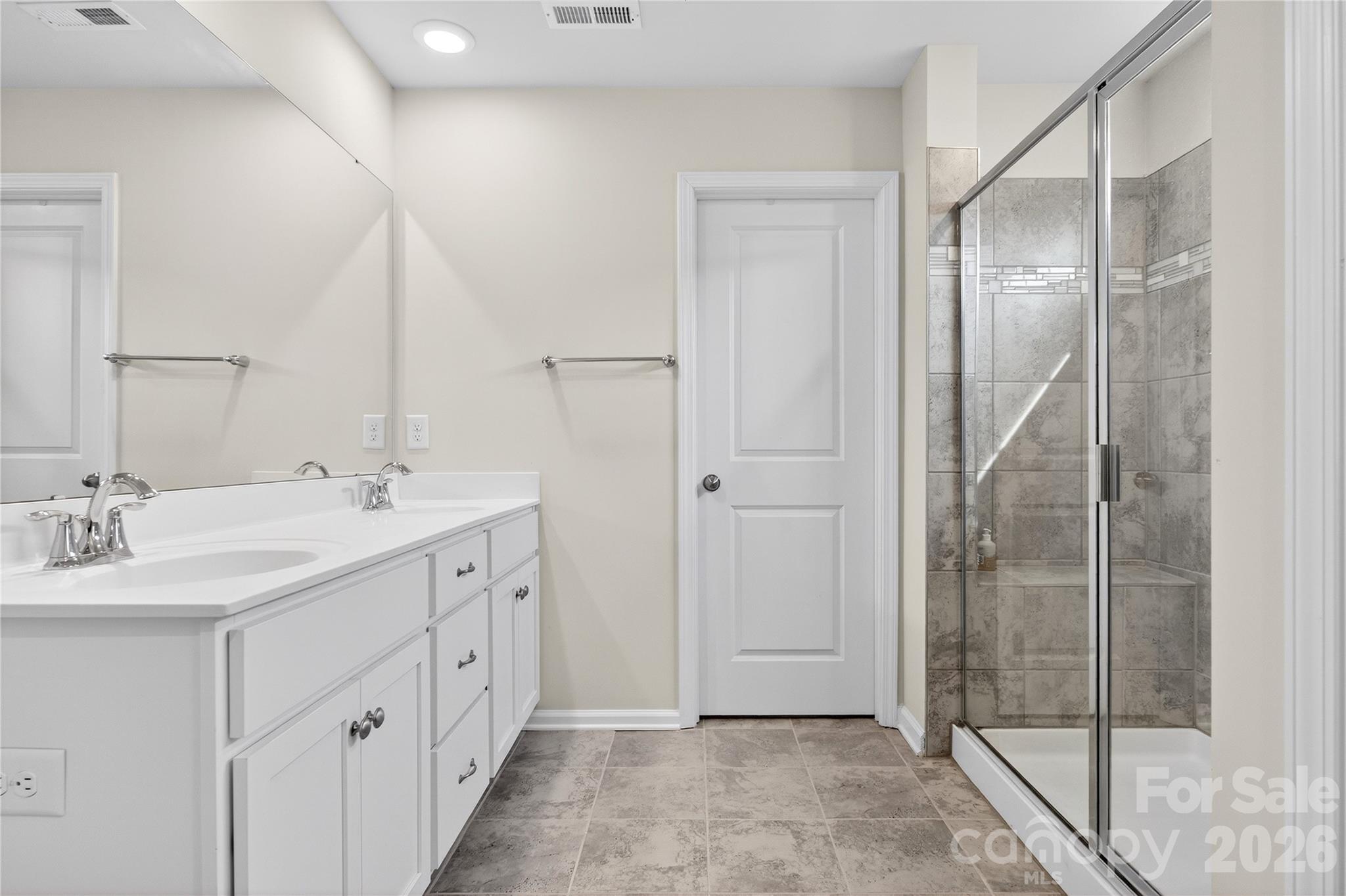 151 Outrigger Lane Troutman, NC 28166 - Photo 34 of 39 a spacious bathroom with a double vanity sink a mirror and shower