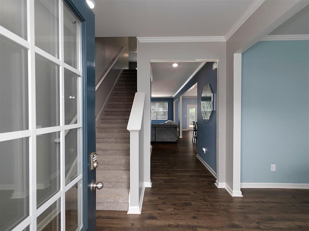 371 Highgrove Circle Dallas, GA 30157 - Photo 7 of 20 a view of a hallway with wooden floor and staircase