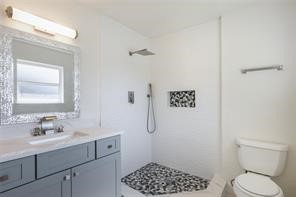 4715 Broken Elm Drive Spring, TX 77388 - Photo 24 of 35 a bathroom with a toilet a sink a shower and a mirror
