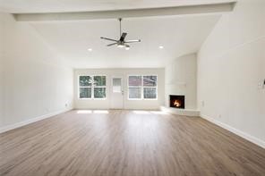 4715 Broken Elm Drive Spring, TX 77388 - Photo 5 of 35 wooden floor in an empty room with a fireplace