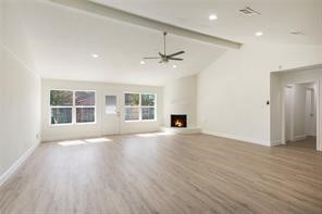 4715 Broken Elm Drive Spring, TX 77388 - Photo 6 of 35 an empty room with wooden floor ceiling fan and windows