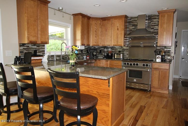 1620 Cortez Road Lake Ariel, PA 18436 - Photo 16 of 80 a kitchen with a table chairs stove and cabinets