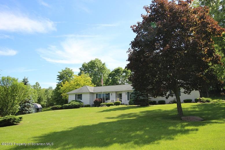 1620 Cortez Road Lake Ariel, PA 18436 - Photo 2 of 80 a front view of a house with a yard and trees