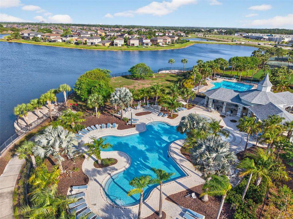 9324 Lemon Drop Loop Sun City Center, FL 33573 - Photo 2 of 32 an aerial view of a house with a lake view