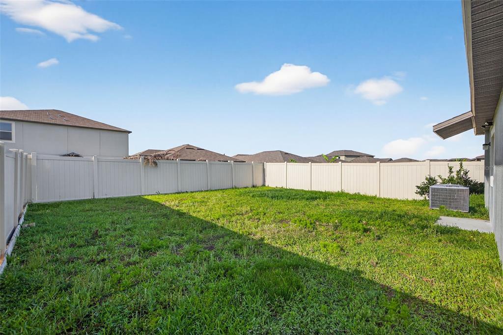 9324 Lemon Drop Loop Sun City Center, FL 33573 - Photo 23 of 32 a view of a backyard