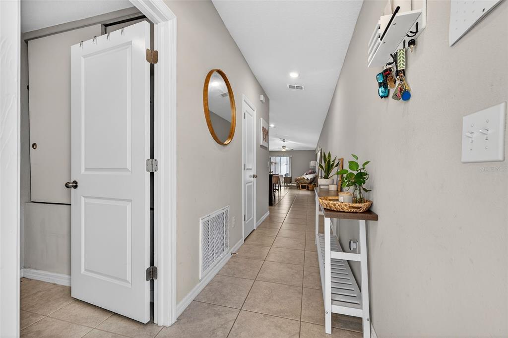 9324 Lemon Drop Loop Sun City Center, FL 33573 - Photo 3 of 32 a view of a hallway with wooden floor and entryway