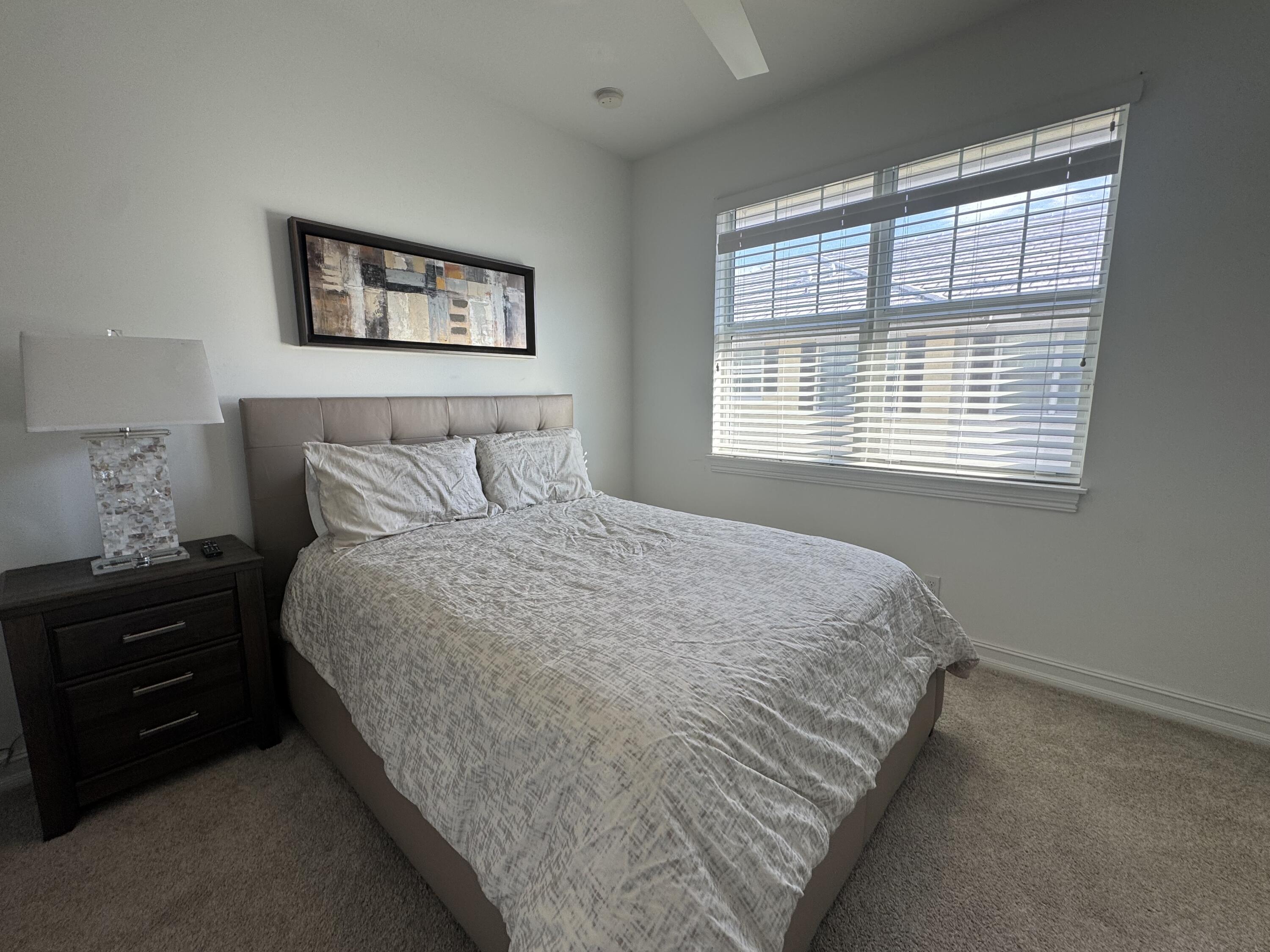 101 East Coda Circle, Unit C Delray Beach, FL 33444 - Photo 12 of 13 a bedroom with a bed and a window