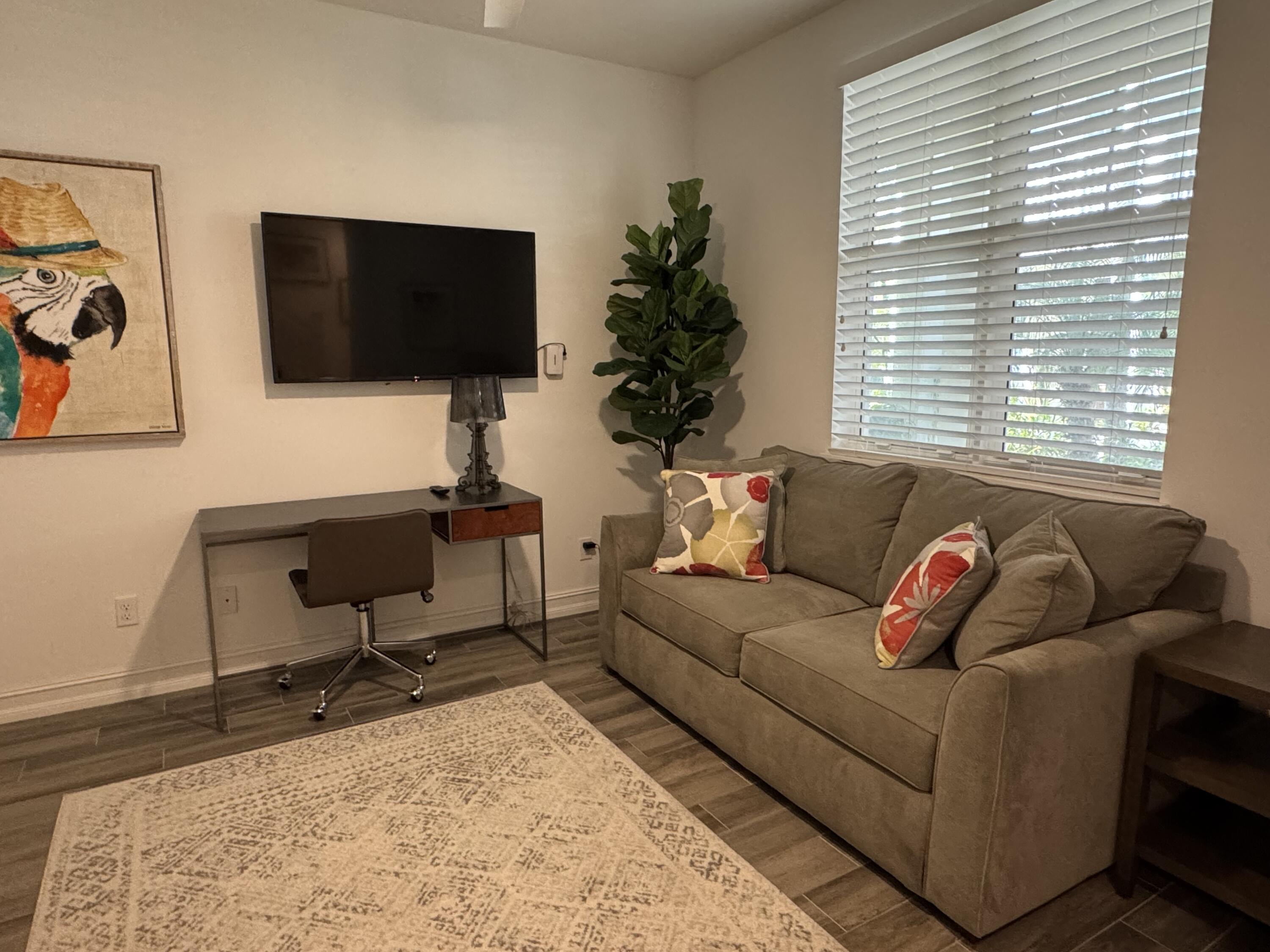 101 East Coda Circle, Unit C Delray Beach, FL 33444 - Photo 2 of 13 a living room with furniture and a flat screen tv