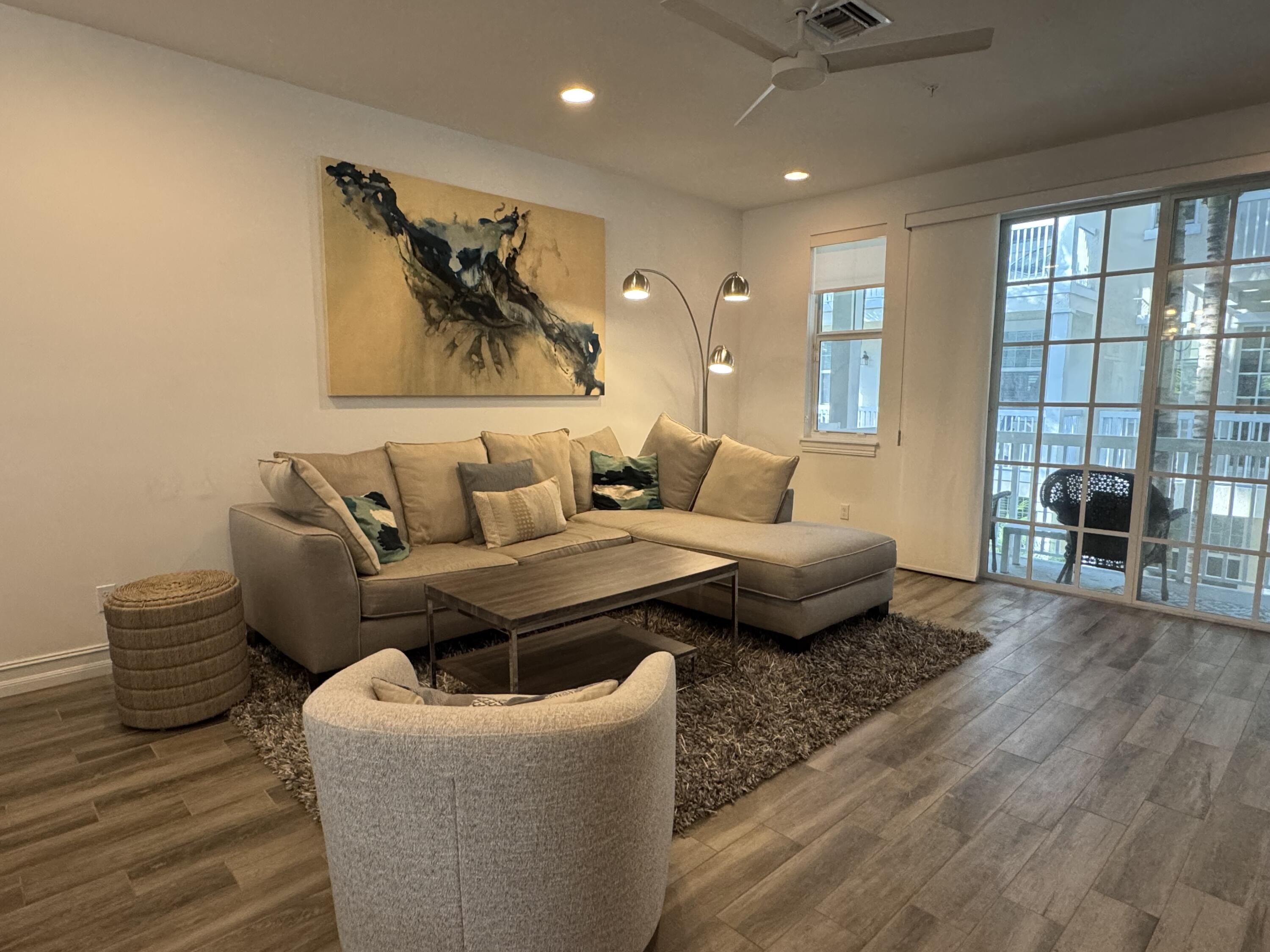 101 East Coda Circle, Unit C Delray Beach, FL 33444 - Photo 3 of 13 a living room with furniture and a large window