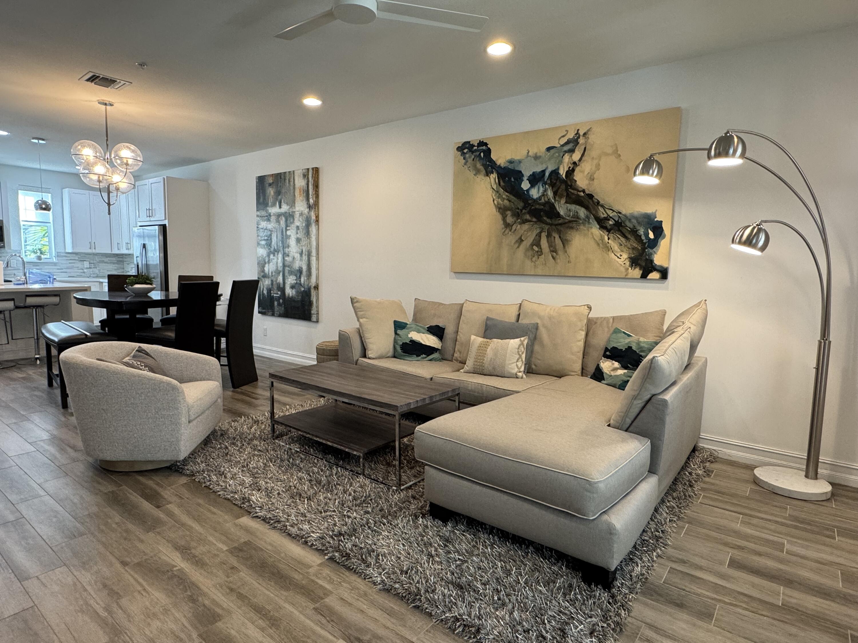 101 East Coda Circle, Unit C Delray Beach, FL 33444 - Photo 4 of 13 a living room with furniture and wooden floor