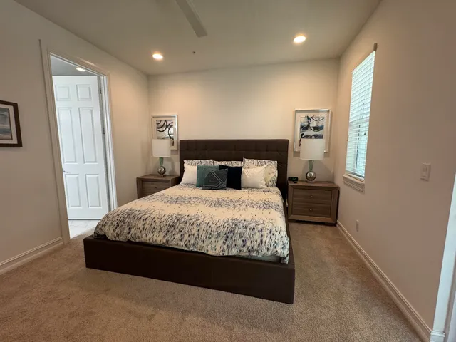 a bedroom with a bed and a night stand