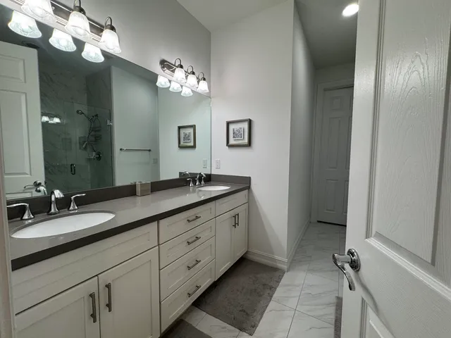 a bathroom with a double vanity sink and a mirror