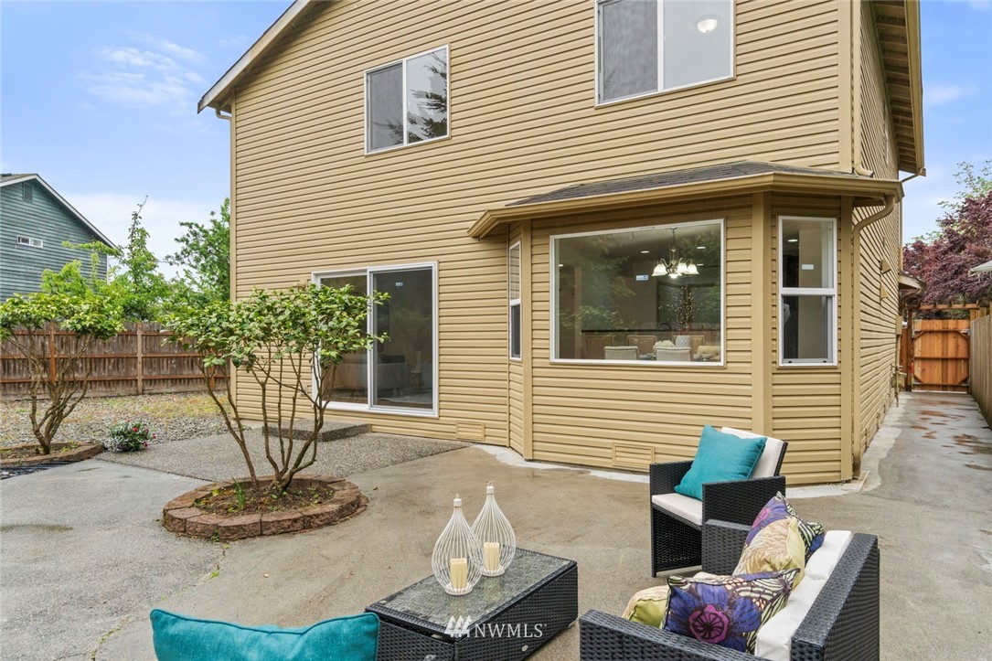 6018 Cady Road Everett, WA 98203 - Photo 15 of 16 a white building with a bench in patio