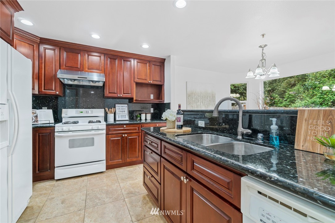 6018 Cady Road Everett, WA 98203 - Photo 4 of 16 a kitchen with a sink stove and cabinets
