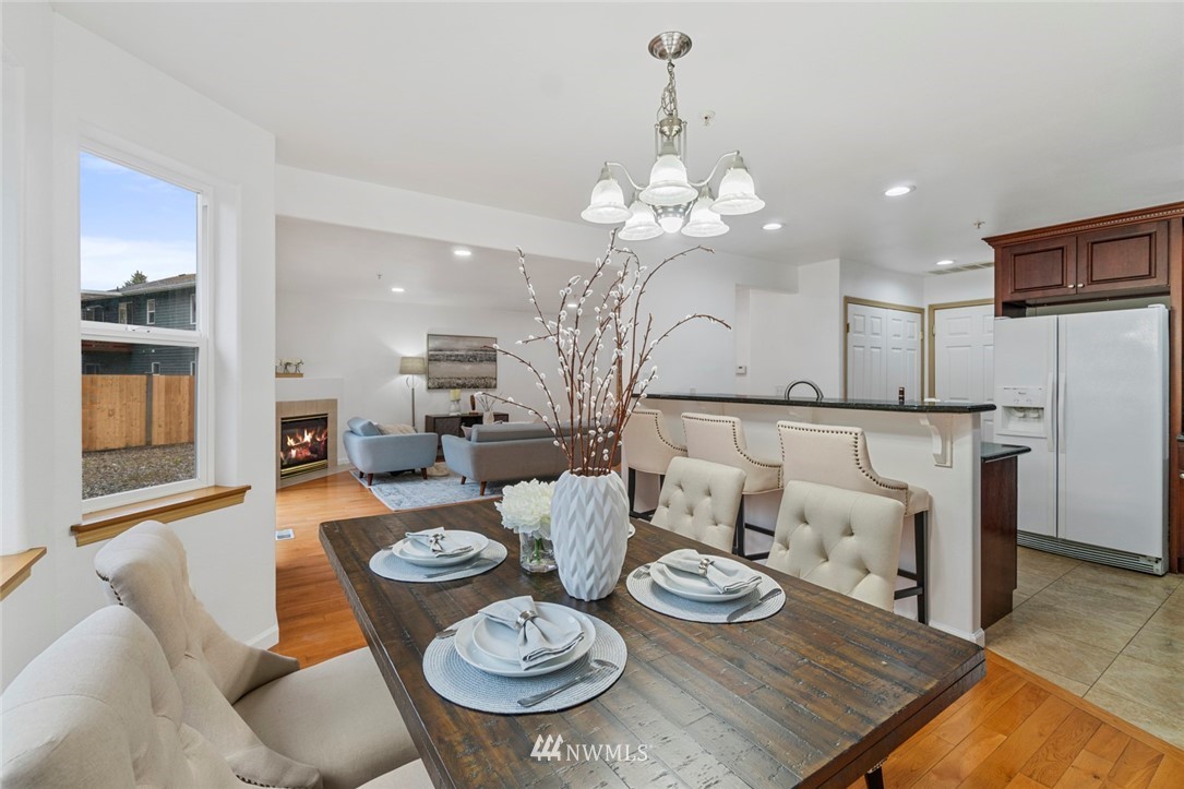 6018 Cady Road Everett, WA 98203 - Photo 6 of 16 a view of a dining room with furniture a chandelier and wooden floor