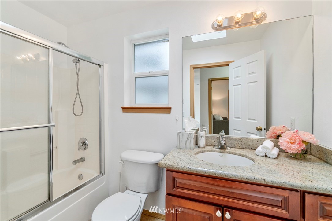 6018 Cady Road Everett, WA 98203 - Photo 10 of 16 a bathroom with a granite countertop sink toilet and shower