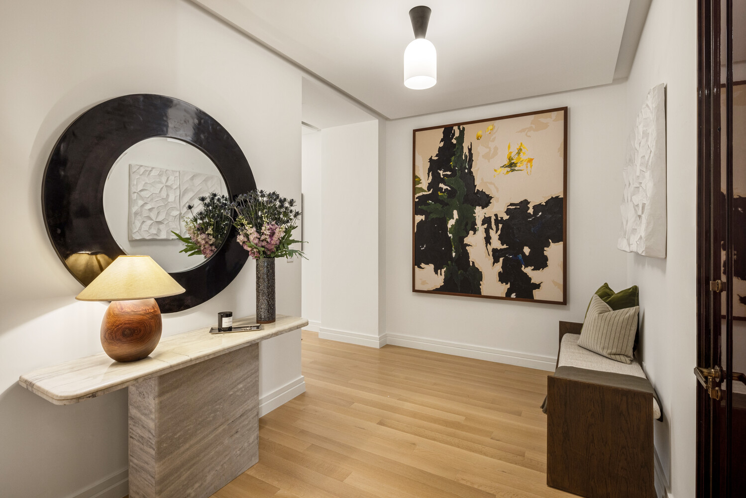 53 West 53rd Street, Unit 19A Manhattan, NY 10019 - Photo 3 of 11 a view of a living room with a potted plant and a large window