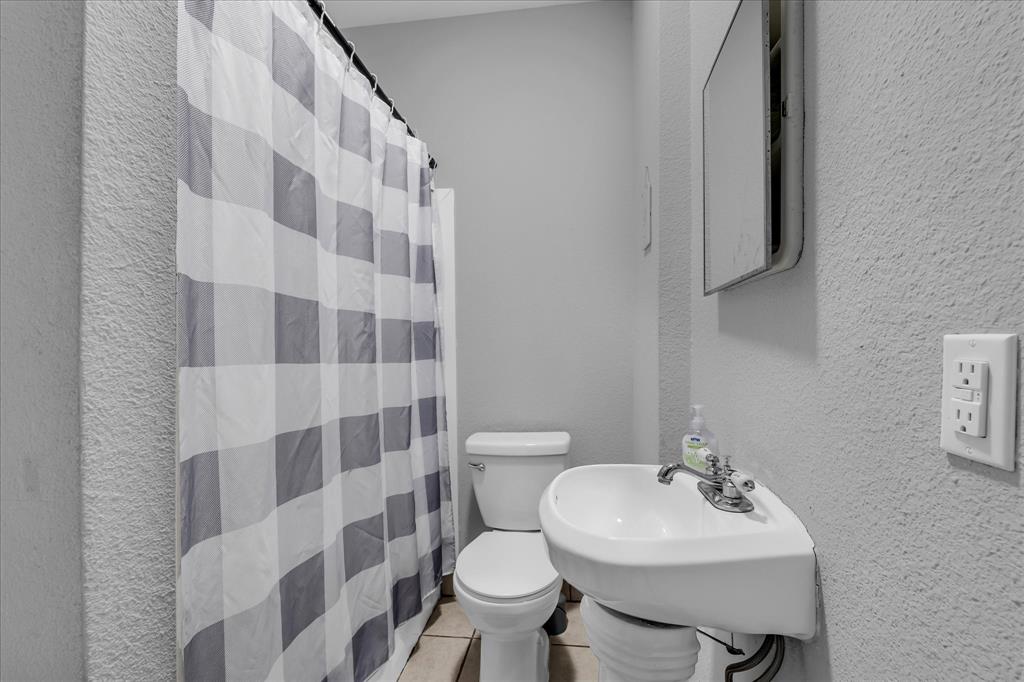 1822 Herring Avenue Waco, TX 76708 - Photo 13 of 27 a bathroom with a sink toilet and a mirror