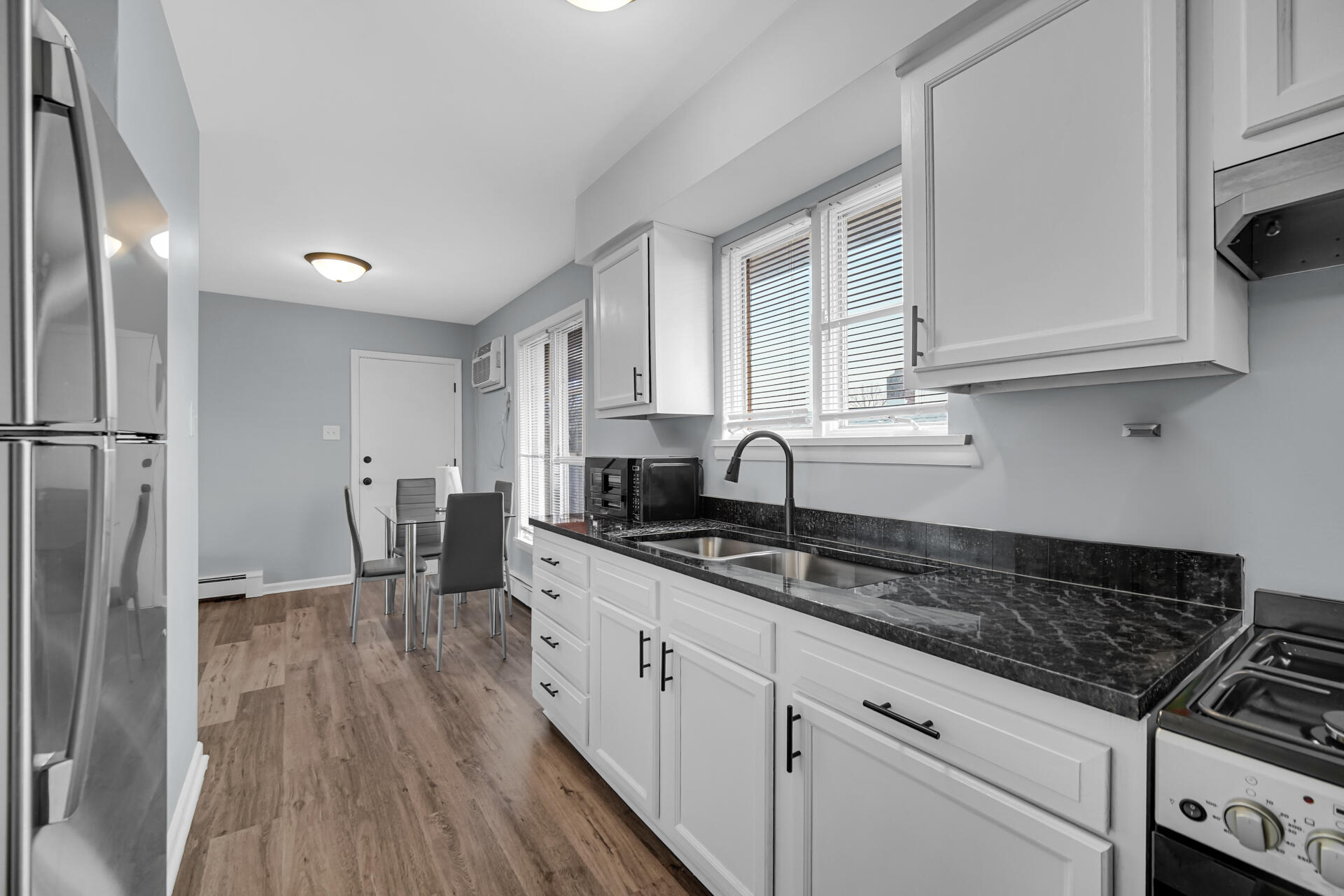 1104 169th Street Hammond, IN 46324 - Photo 11 of 20 a kitchen with granite countertop a sink stove and cabinets