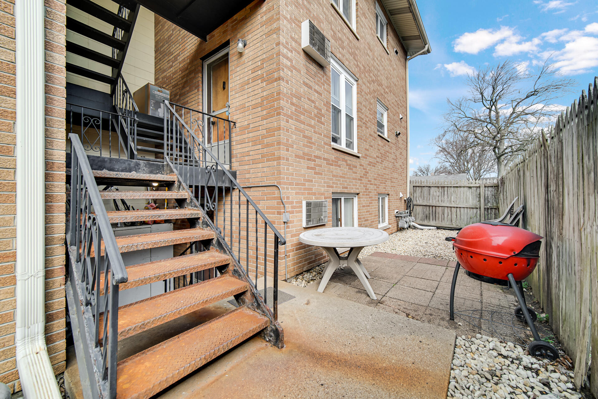 1104 169th Street Hammond, IN 46324 - Photo 18 of 20 a view of a chairs with barbeque grill and wooden floor