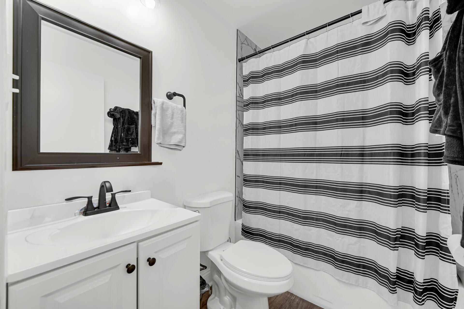 1104 169th Street Hammond, IN 46324 - Photo 4 of 20 a bathroom with a sink a toilet and mirror