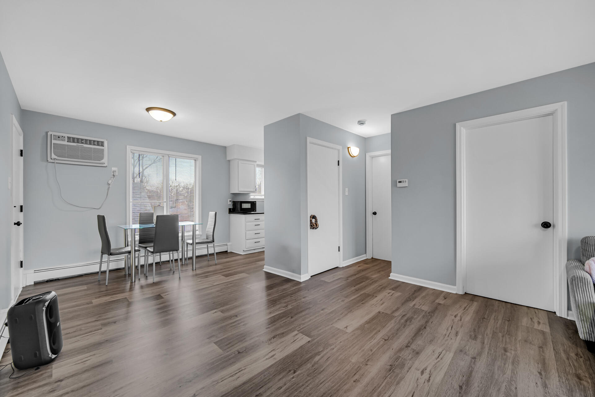 1104 169th Street Hammond, IN 46324 - Photo 6 of 20 a view of an empty room with wooden floor and a window