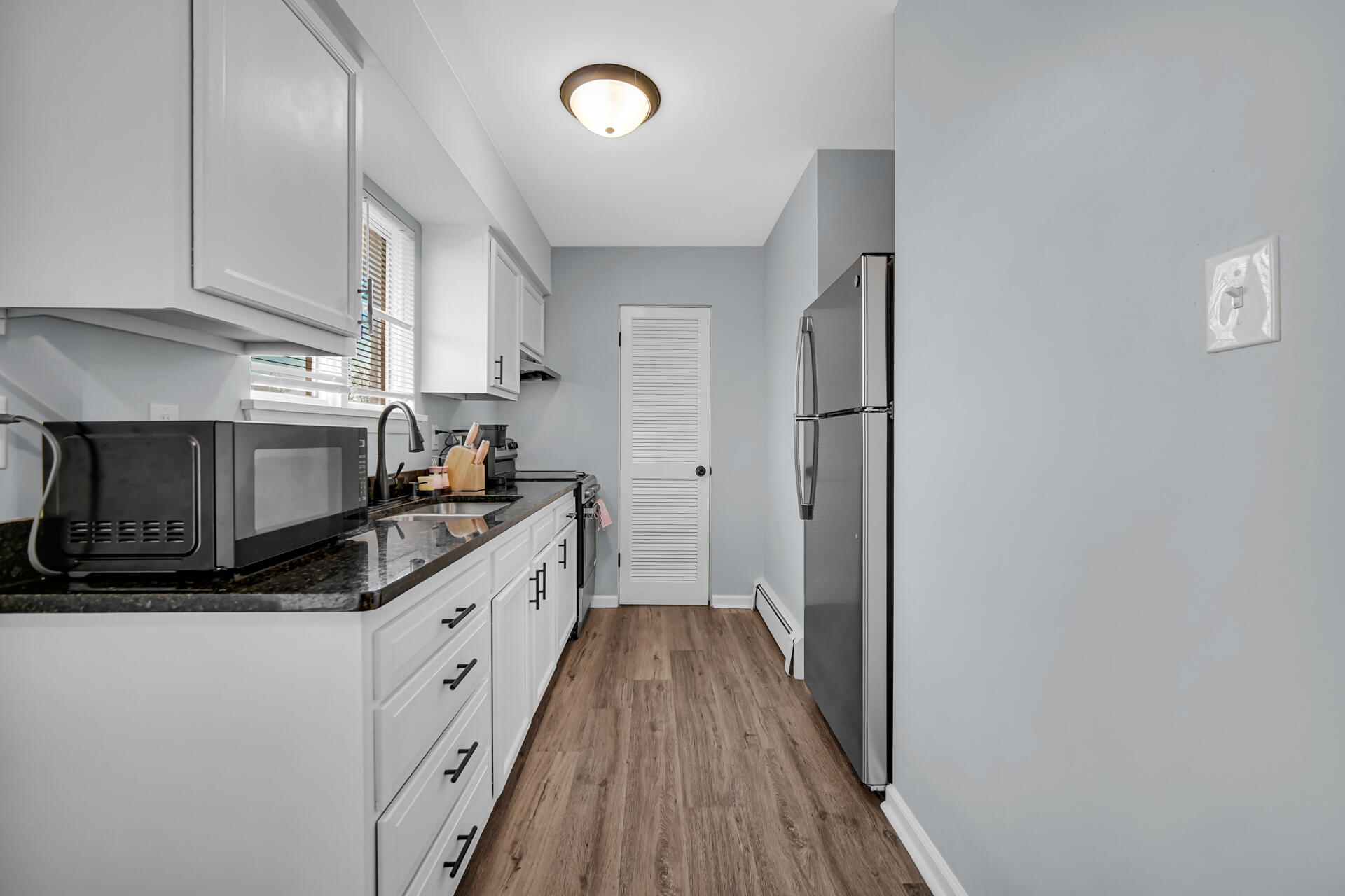 1104 169th Street Hammond, IN 46324 - Photo 9 of 20 a kitchen with stainless steel appliances granite countertop a stove a sink and a refrigerator