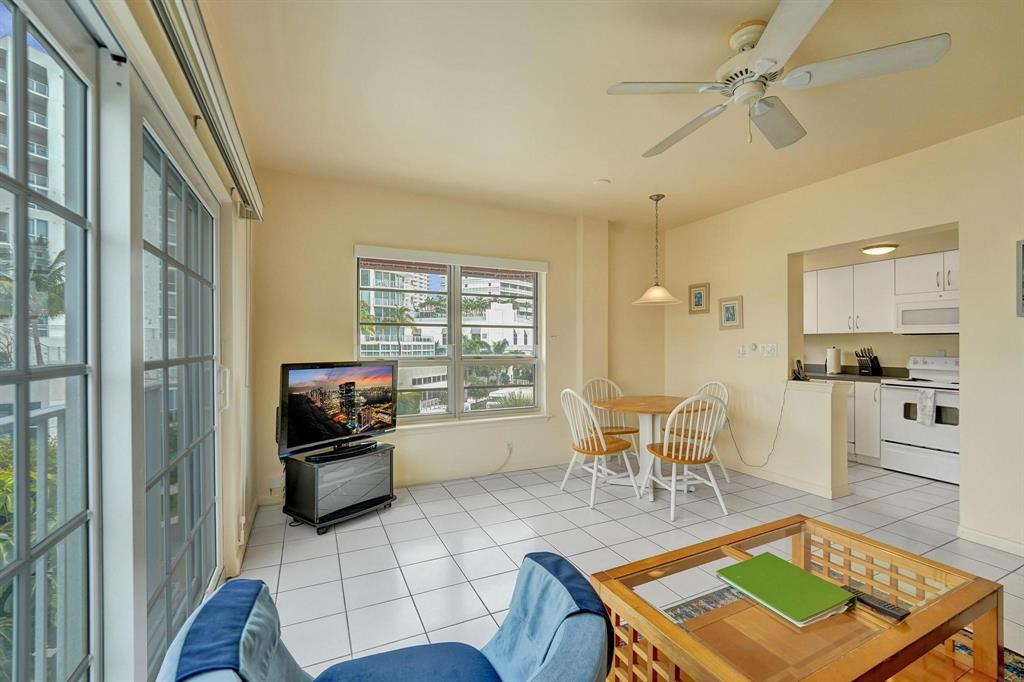 341 North Birch Road, Unit 416 Fort Lauderdale, FL 33304 - Photo 24 of 49 a living room with furniture a rug and a view of kitchen