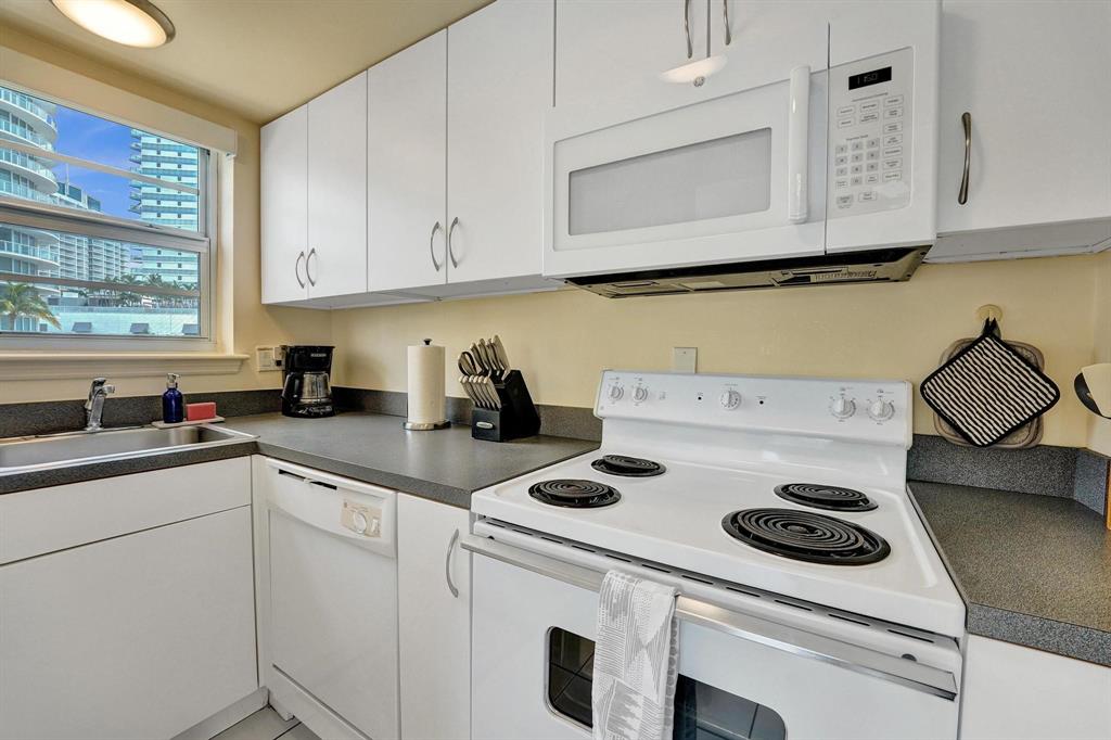 341 North Birch Road, Unit 416 Fort Lauderdale, FL 33304 - Photo 36 of 49 a kitchen with a stove and white cabinets