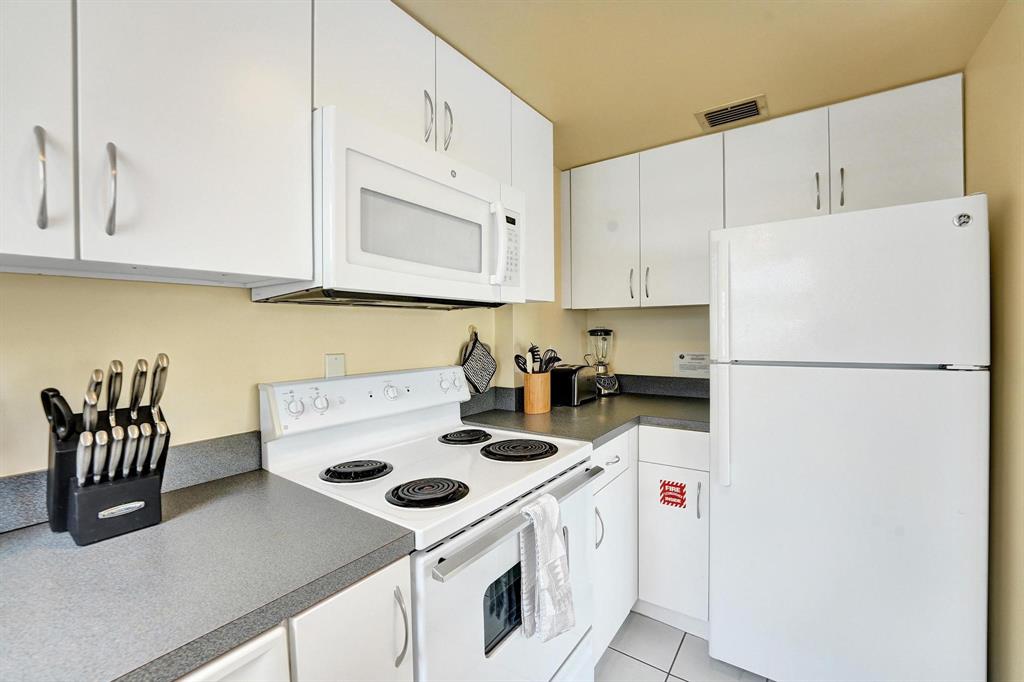 341 North Birch Road, Unit 416 Fort Lauderdale, FL 33304 - Photo 37 of 49 a kitchen with a white stove top oven and white countertops