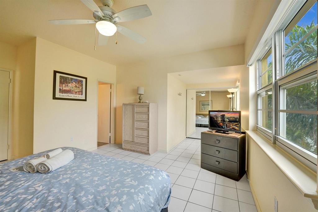 341 North Birch Road, Unit 416 Fort Lauderdale, FL 33304 - Photo 40 of 49 a large bedroom with a bed and wooden floor